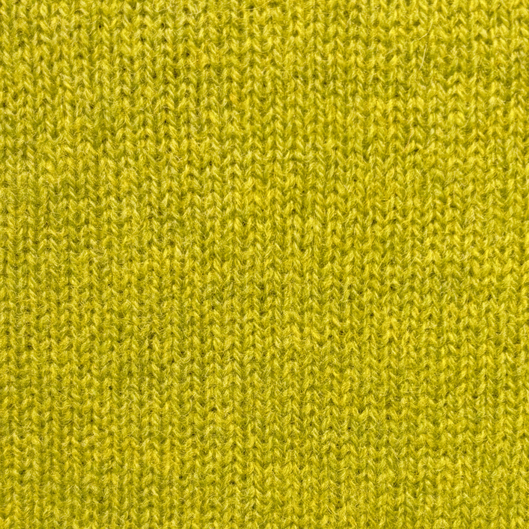 Close-up of a textured, yellow-green knit fabric.