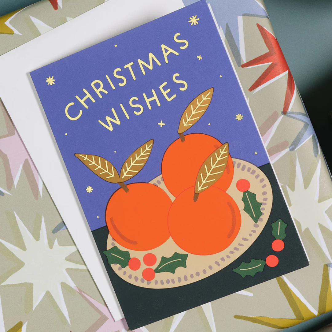 Christmas card with oranges and 'Christmas Wishes' text on a colorful background