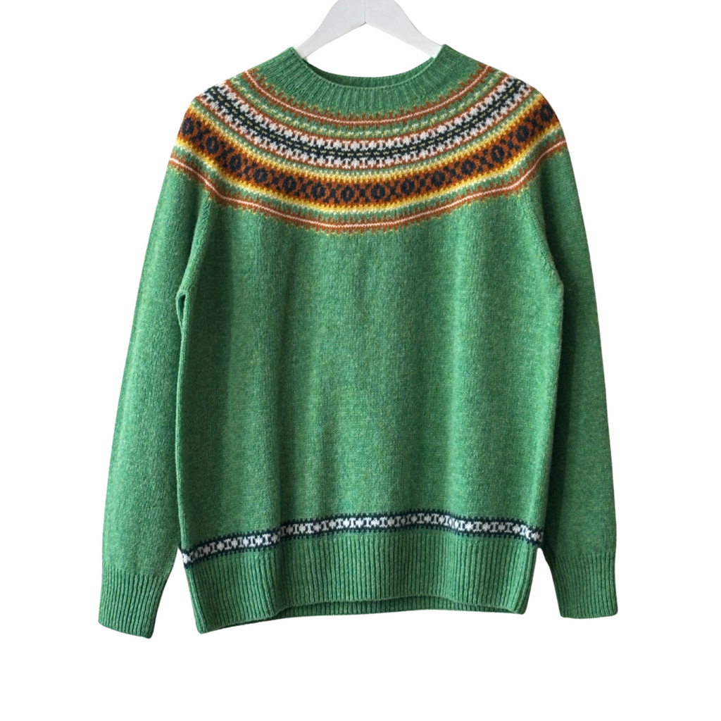 Green crewneck wool sweater with a Fair Isle-style yoke and hem detailing in orange, cream, and navy.