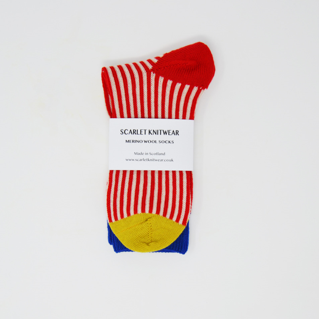Pair of red and cream striped merino wool socks with yellow and blue cuffs.  Made in Scotland.