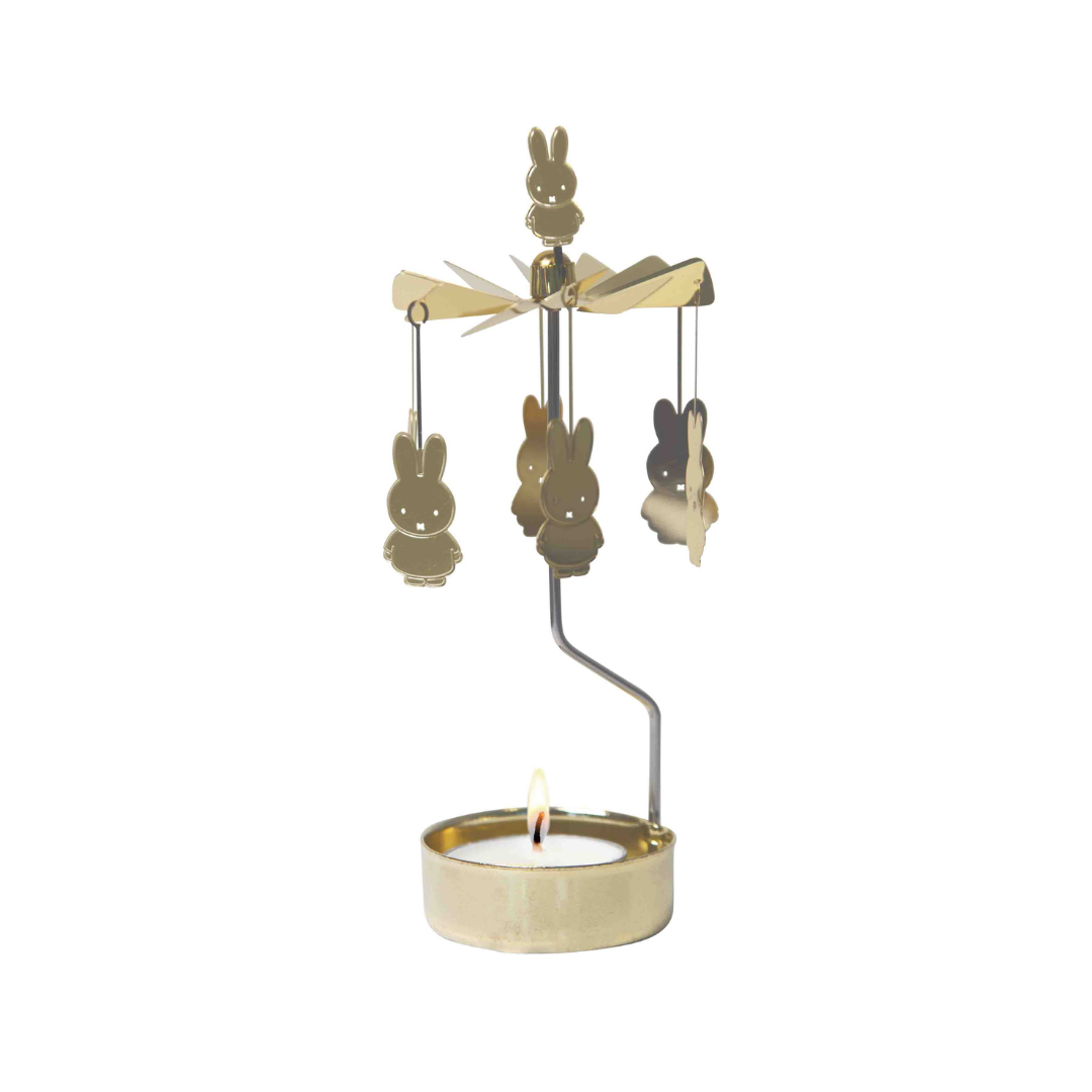 Gold metal Miffy candleholder with spinning bunny design and lit tea light.