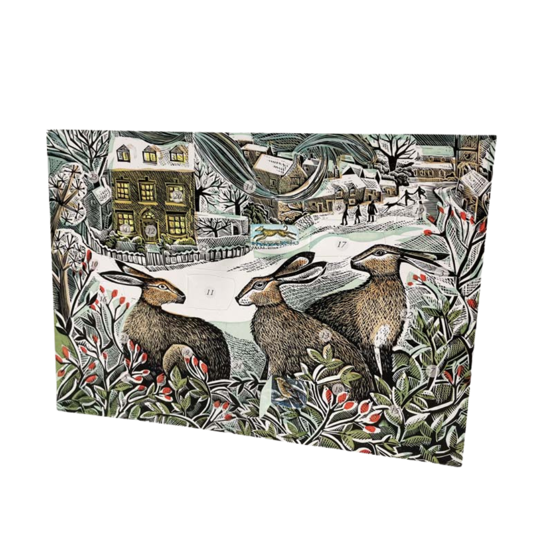An advent card featuring artwork with three hares in a natural setting, with holly and berries in the foreground.