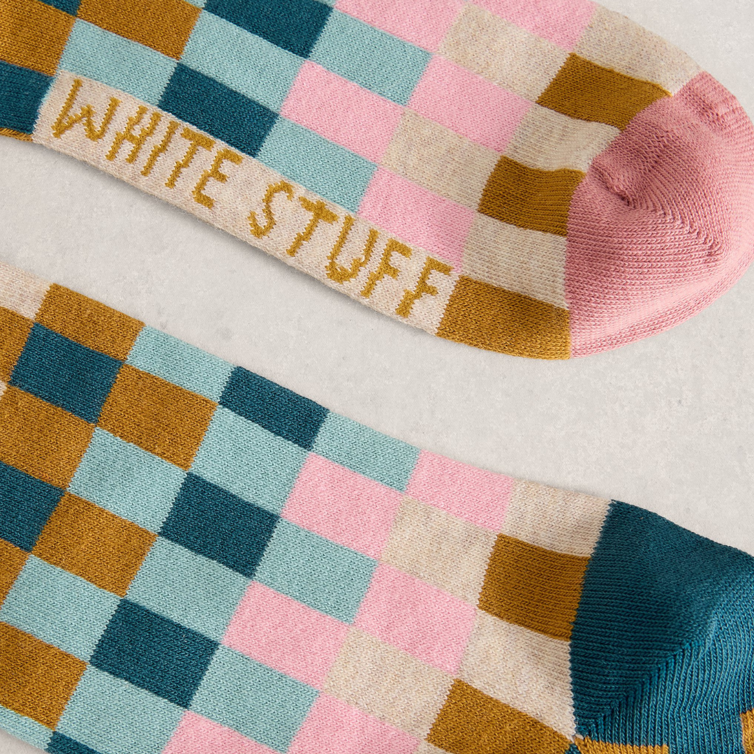 Colorful checkered socks with 'White Stuff' text on a light background