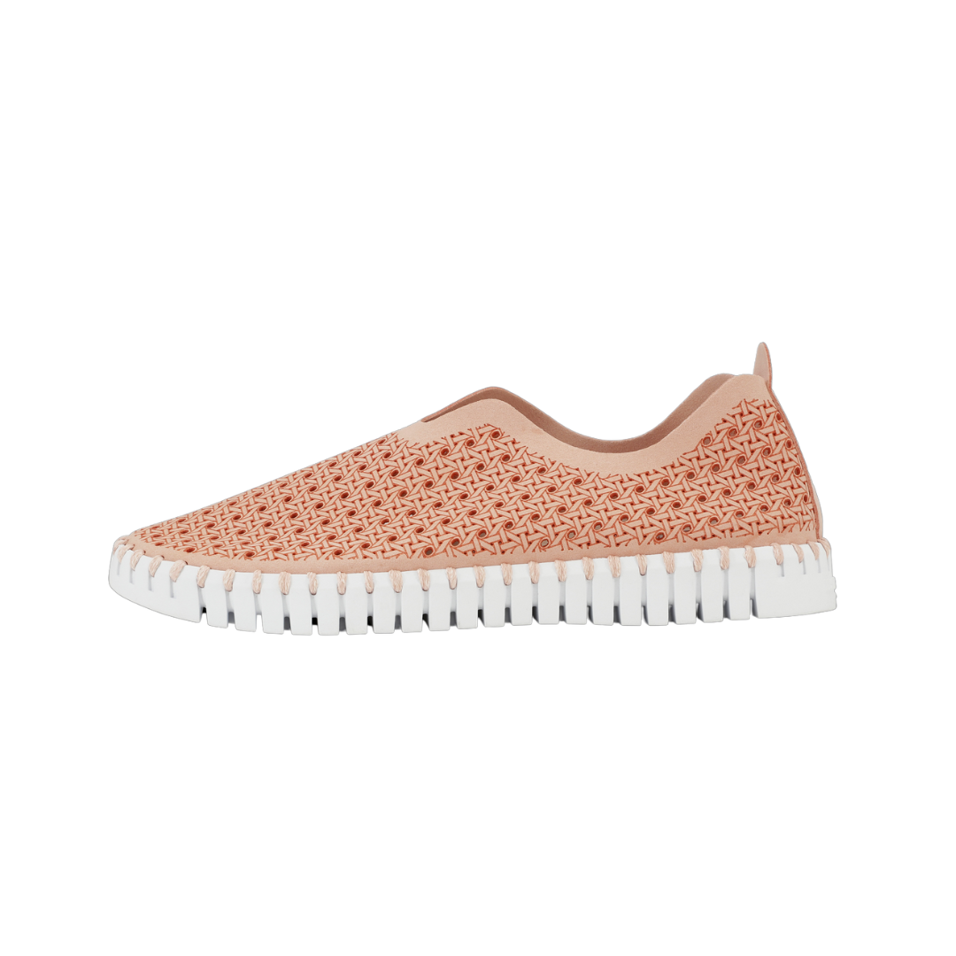 Peach slip-on sneaker with woven textured upper and white, ridged sole.