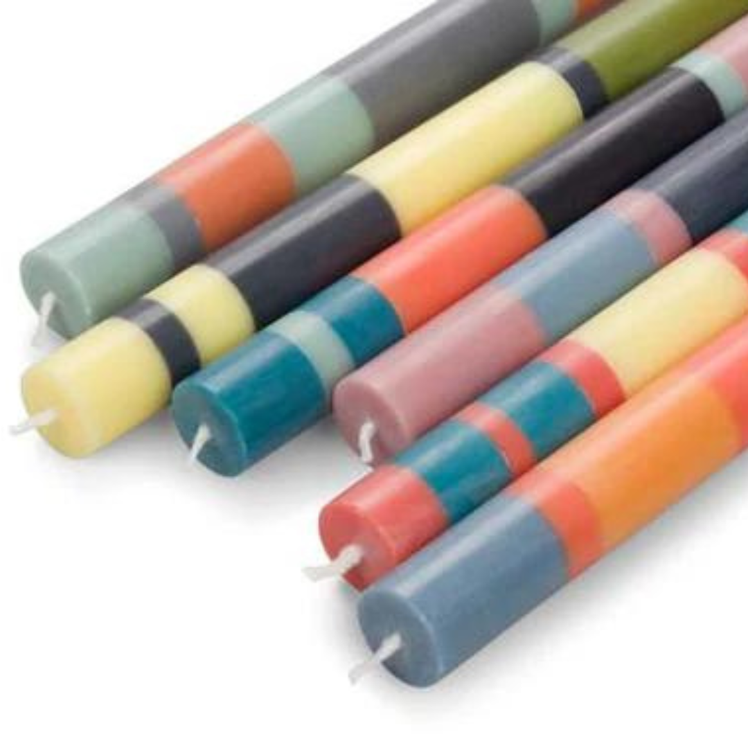 Multicolored striped taper candles.  Each candle features several horizontal bands of pastel and darker shades.