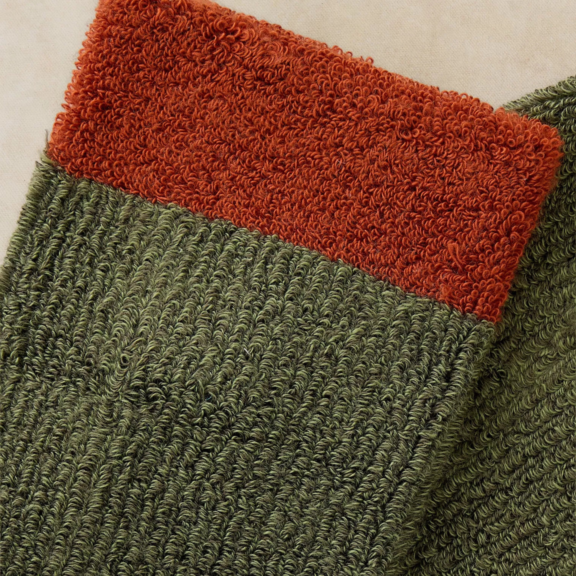 Close-up of a green and rust-colored textured fabric