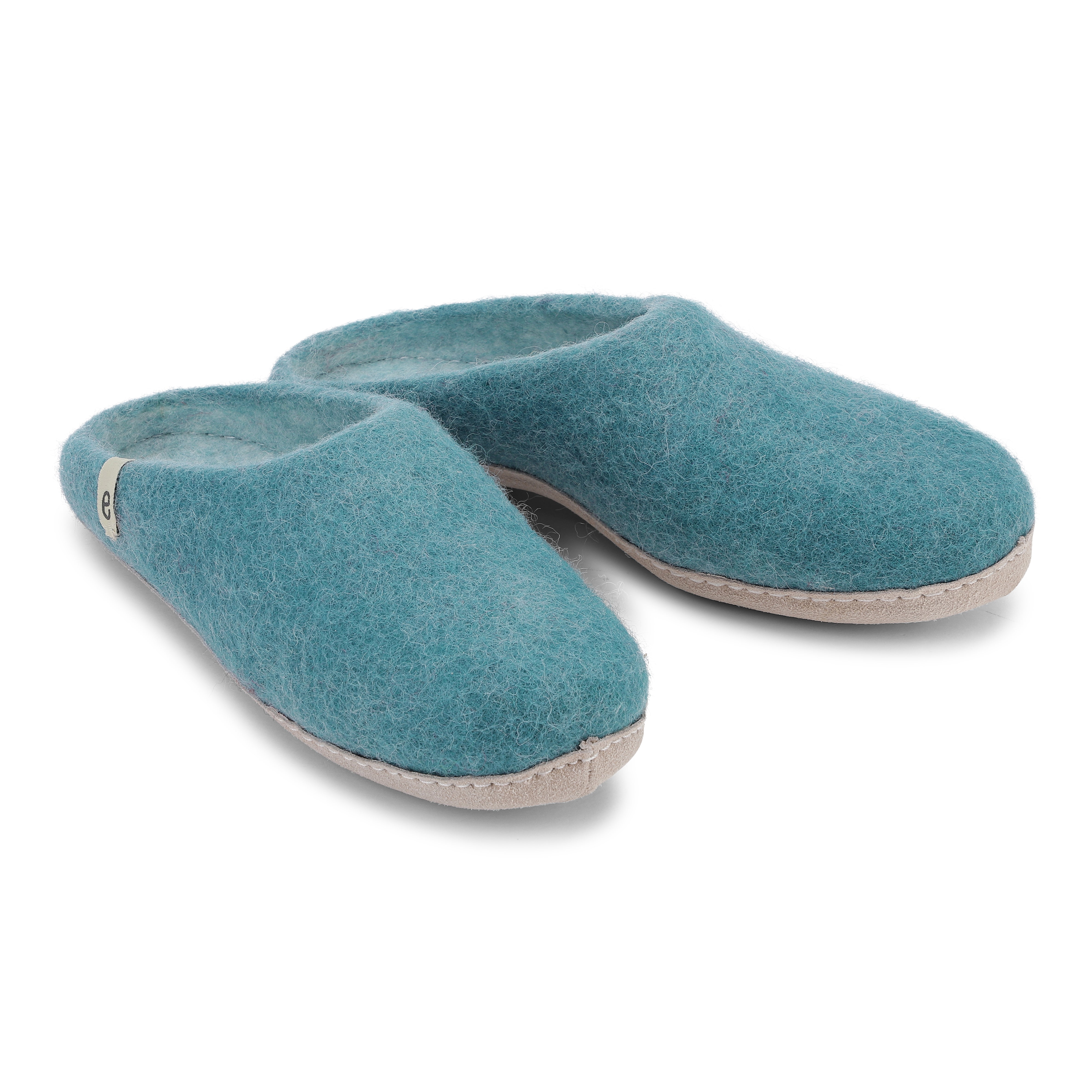 Pair of teal felted wool slippers with light beige soles.