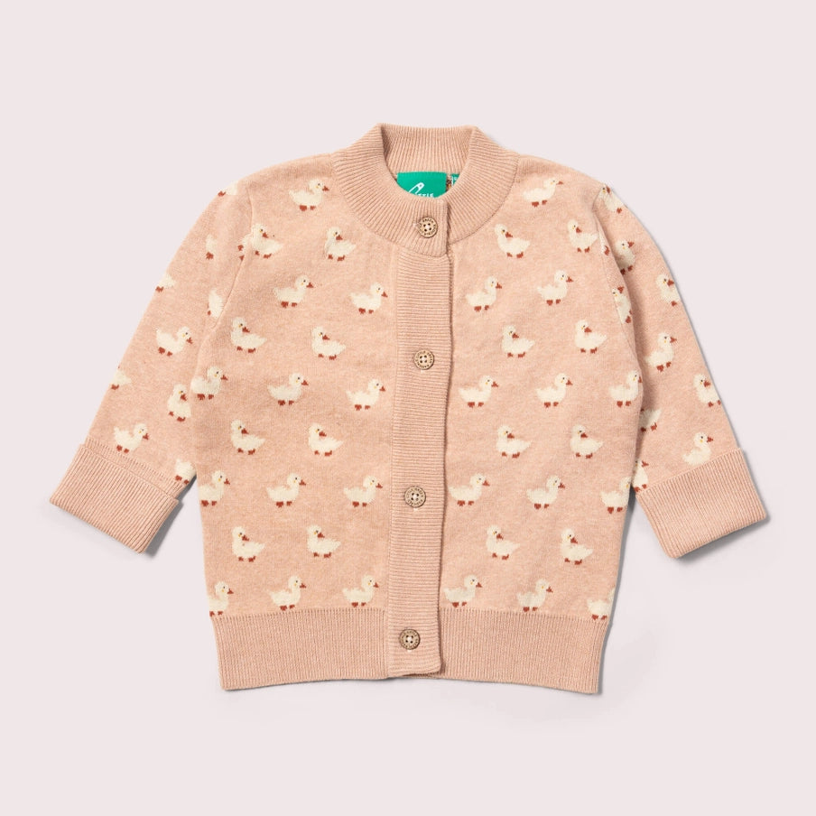 Pink cardigan with duck pattern on a light gray background