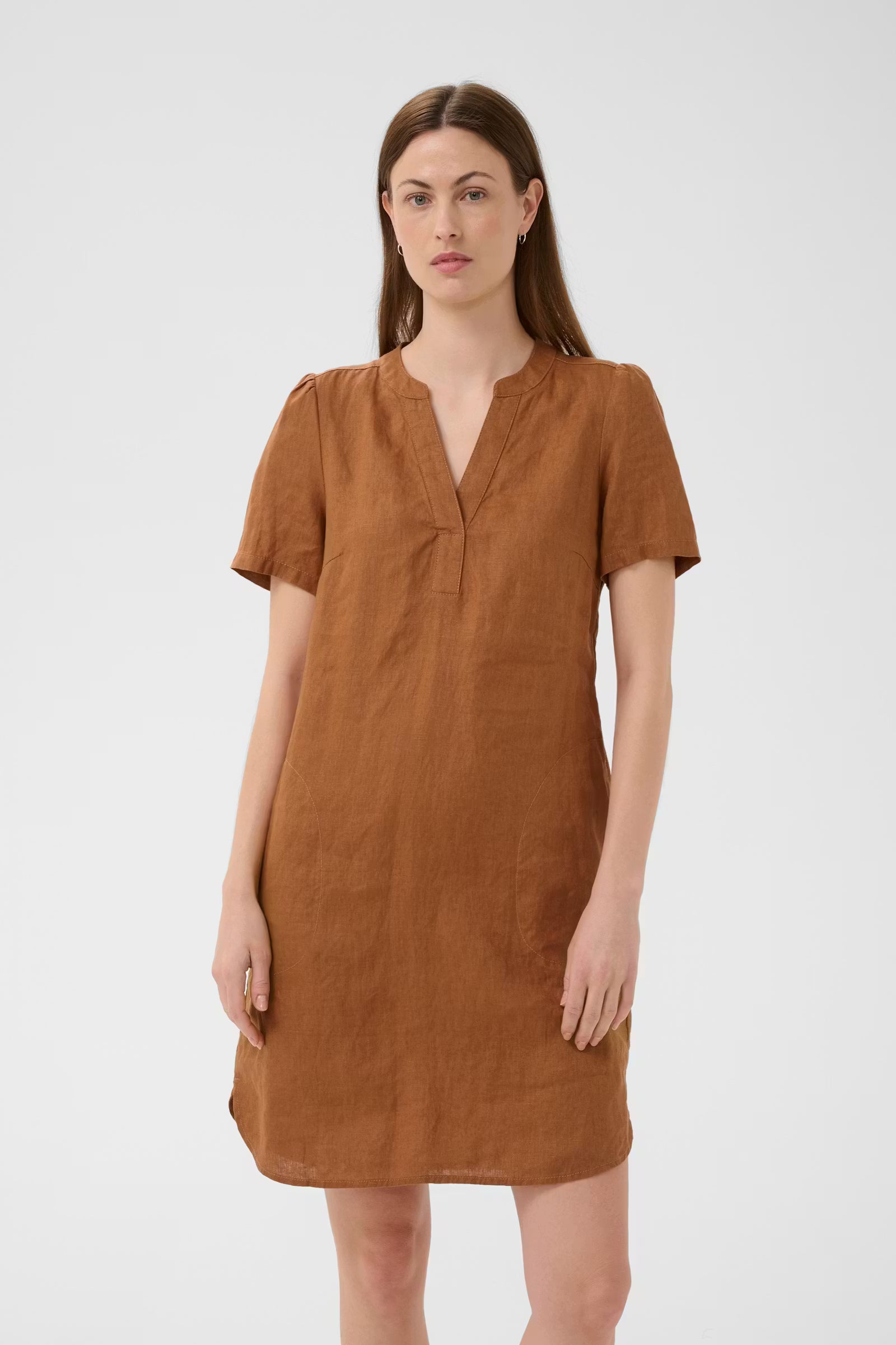 Woman wearing a brown dress against a white background