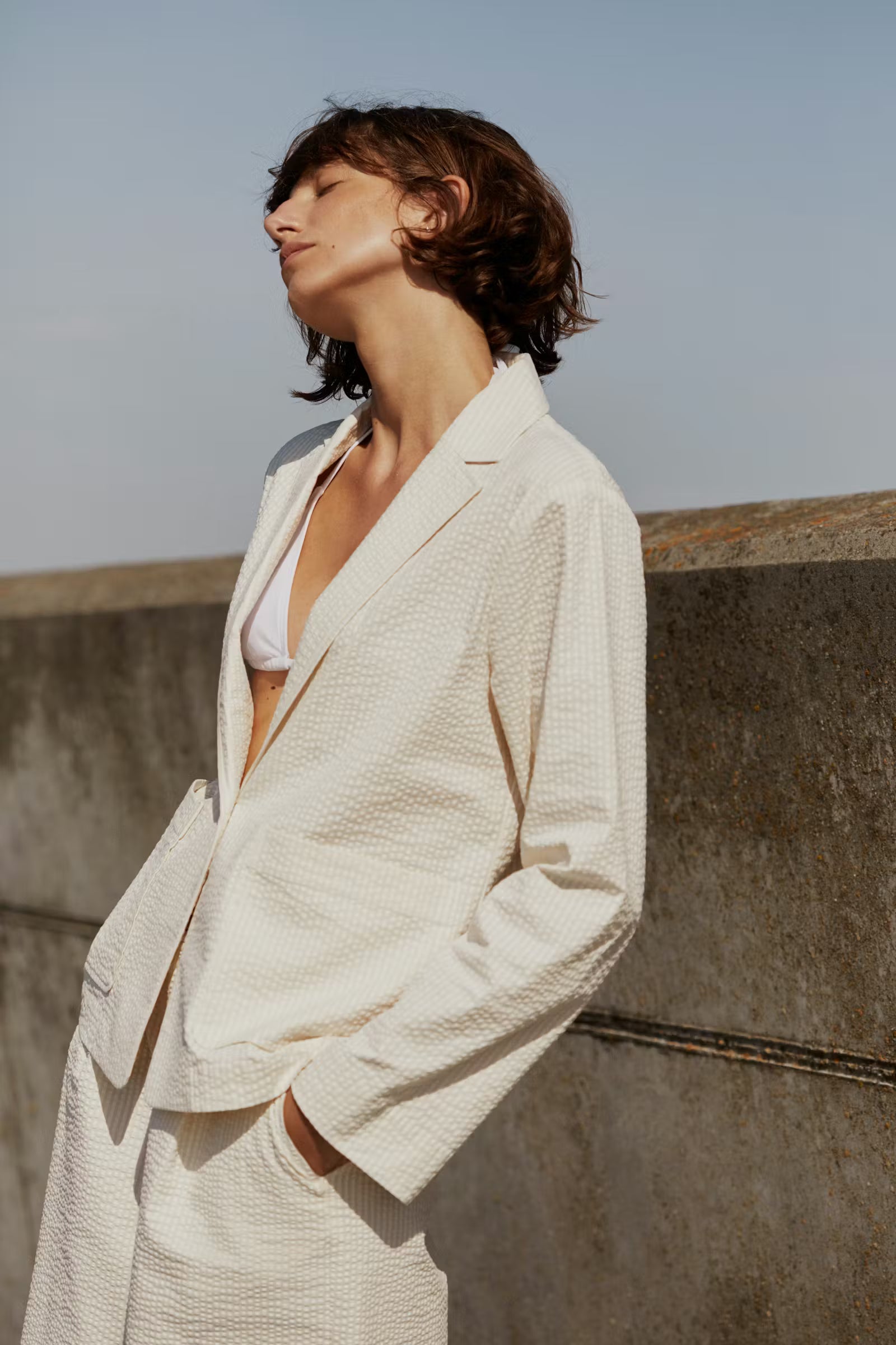 women wearing a cream seersucker jacket