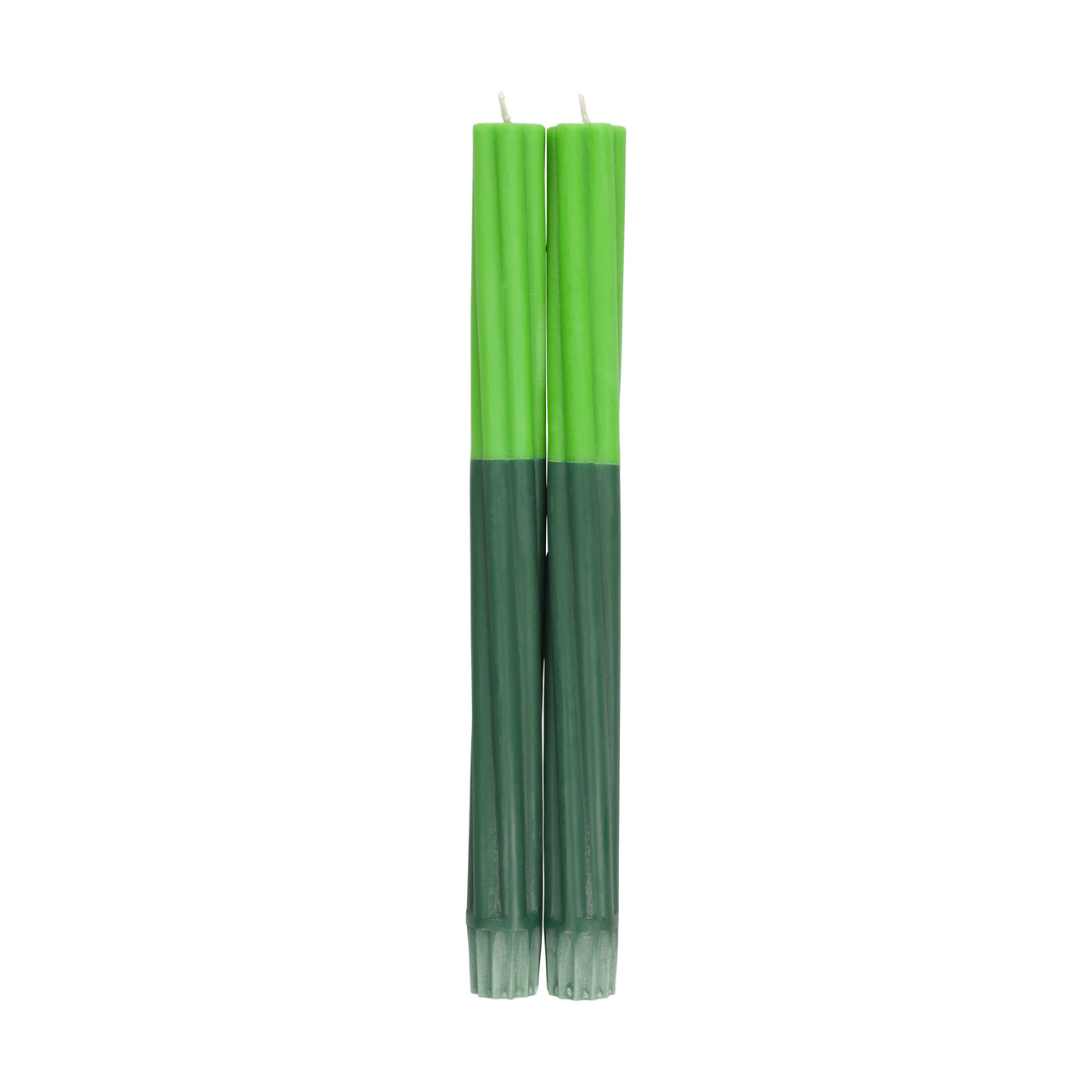 Two green taper candles with a textured surface; the top half is a lighter green, the bottom a darker shade.