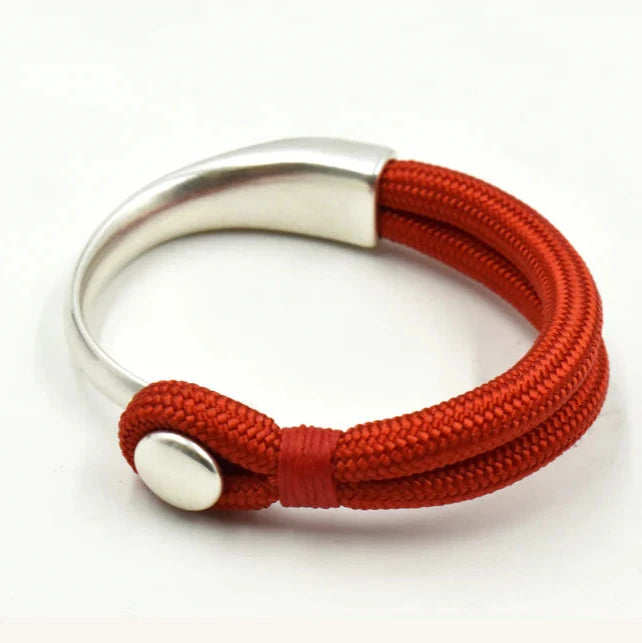 A red and silver bracelet with a metallic clasp on a white background.