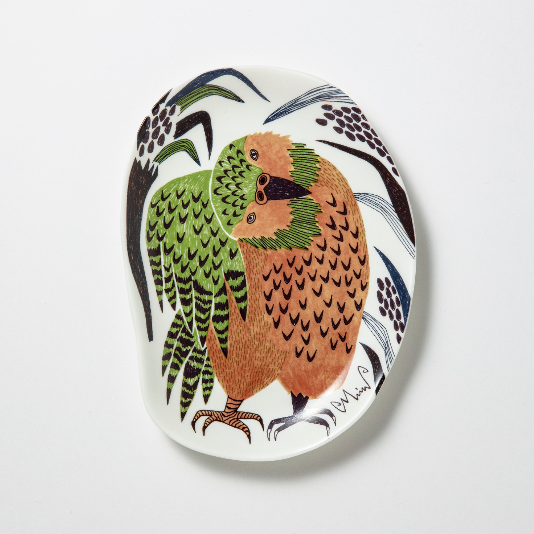 Decorative plate with a colorful bird design on a white background