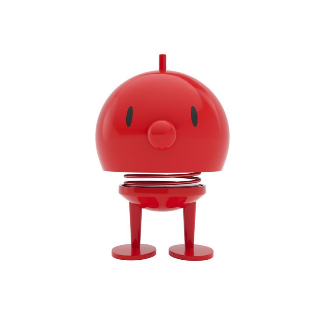 Red bobblehead toy with a spring, small legs, and a simple face.