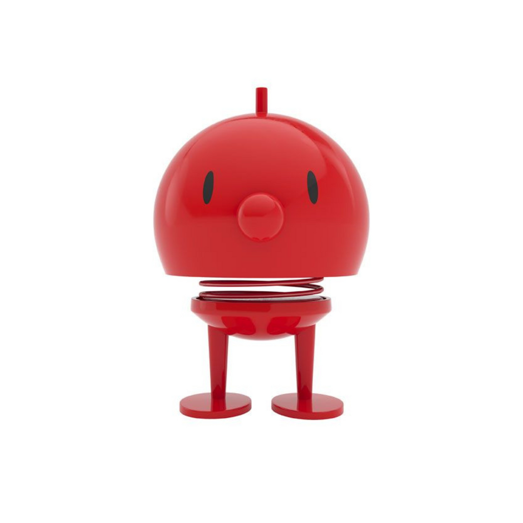 Red bobblehead toy with a spring, small legs, and a simple face.