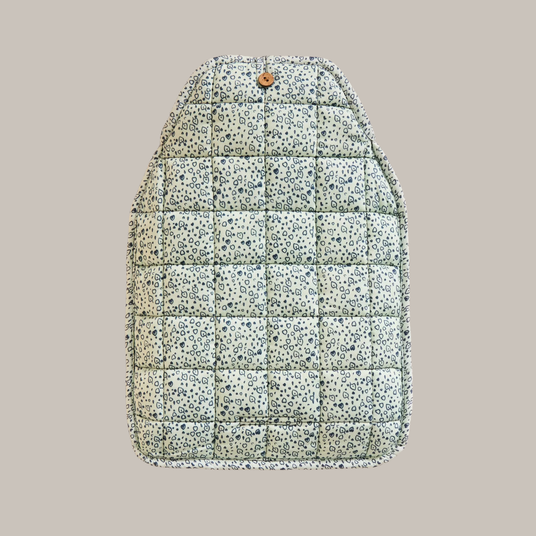 Quilted car seat cover with a light green background and a dark blue small heart pattern.