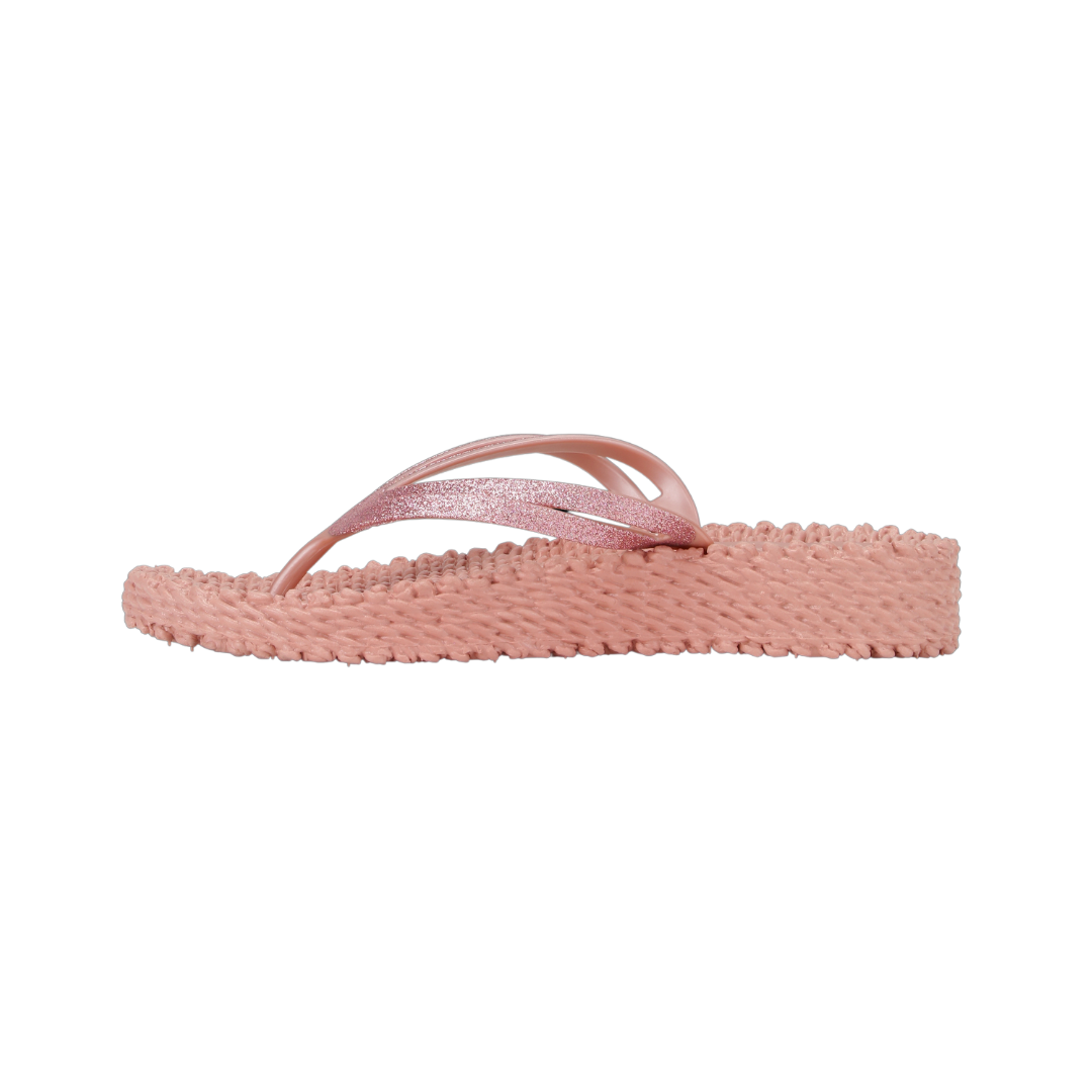 Dusty rose glitter-strap flip-flop with textured sole. Side view shows low wedge heel.