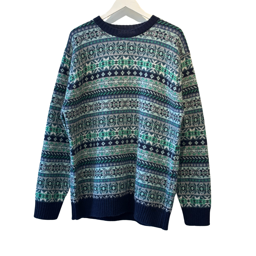 Fair isle crewneck sweater in teal, green, and navy with a repeating geometric pattern.