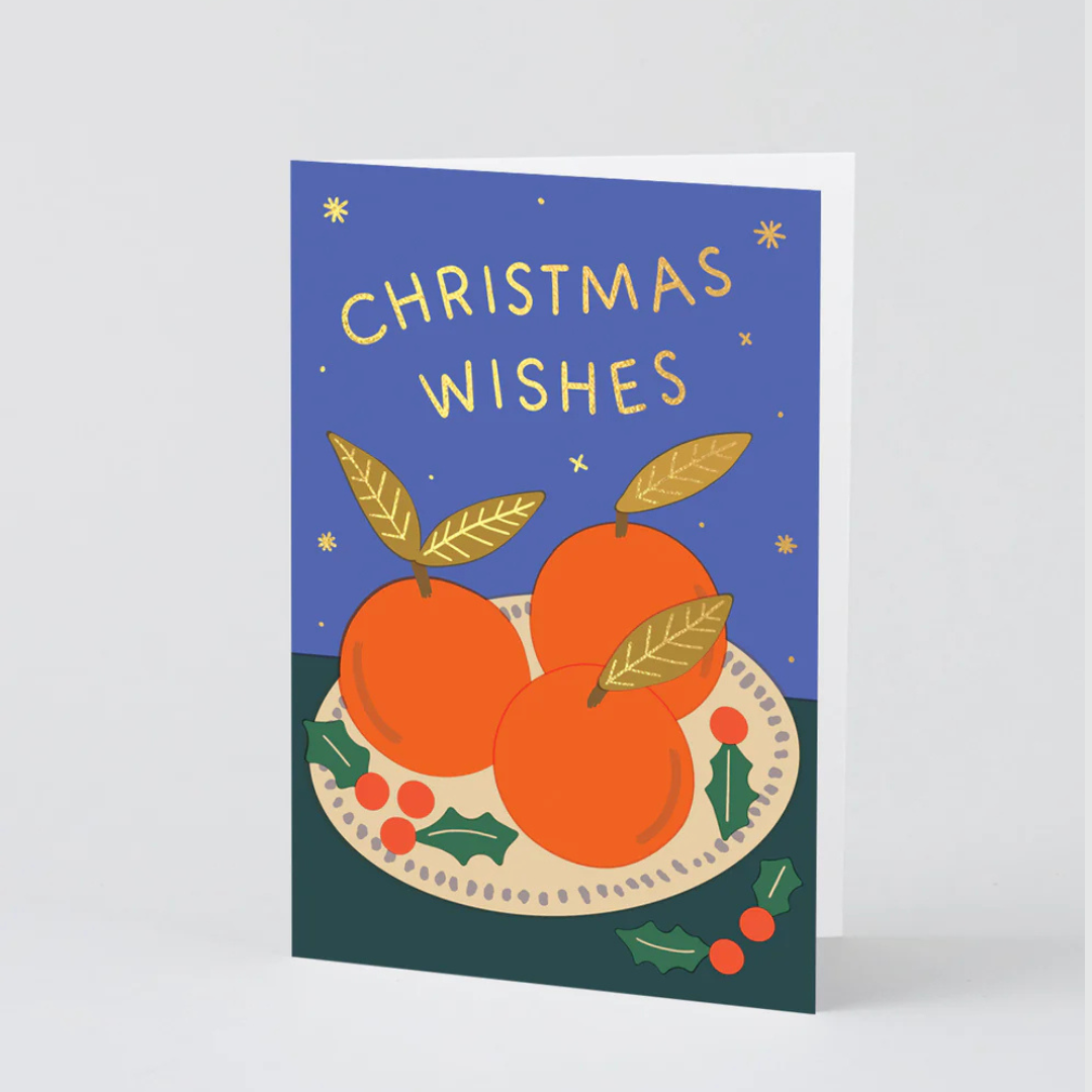 Christmas card with oranges and 'Christmas Wishes' text on a blue background