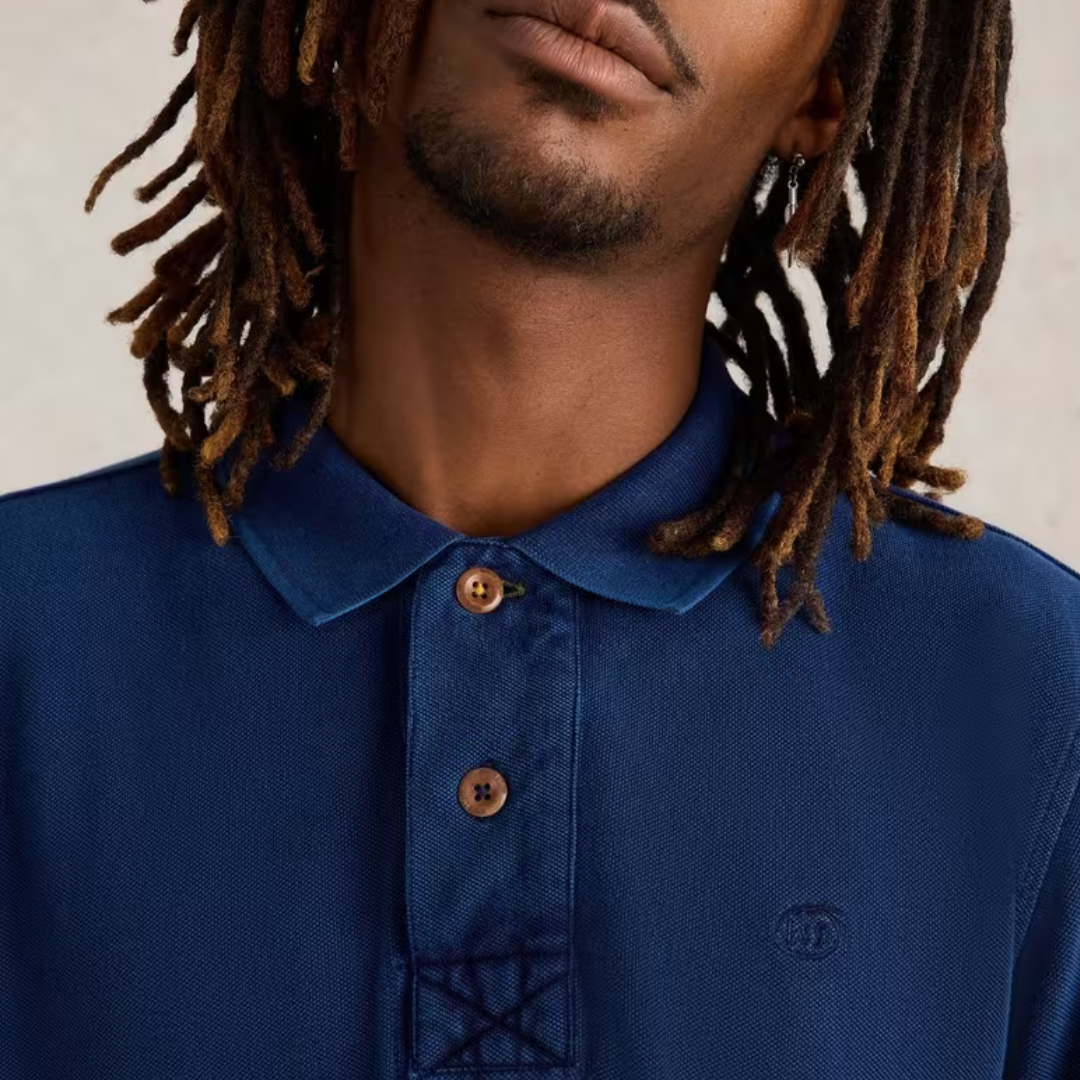 Dark blue long-sleeve polo shirt with wooden buttons and small embroidered logo.