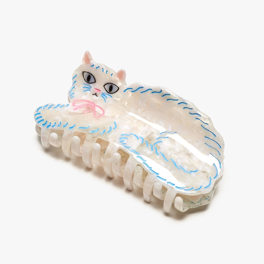 Cat-shaped hair clip with white and blue design on a white background