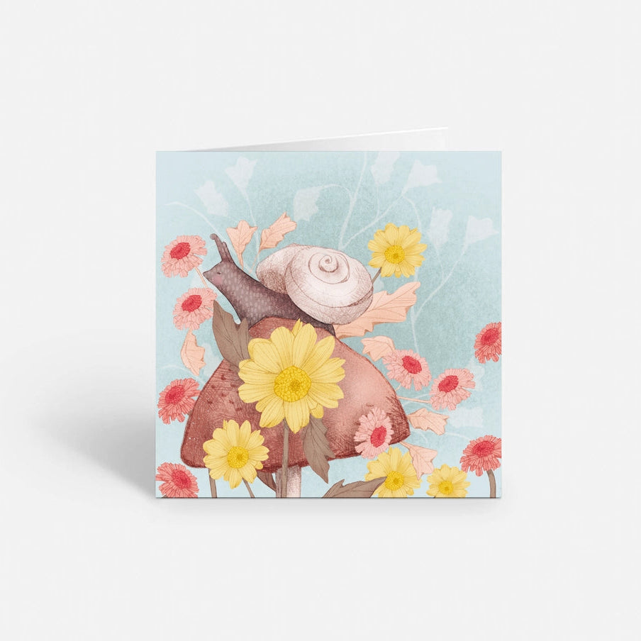 Snail on a mushroom surrounded by flowers.  Pastel colored illustration on a greeting card.