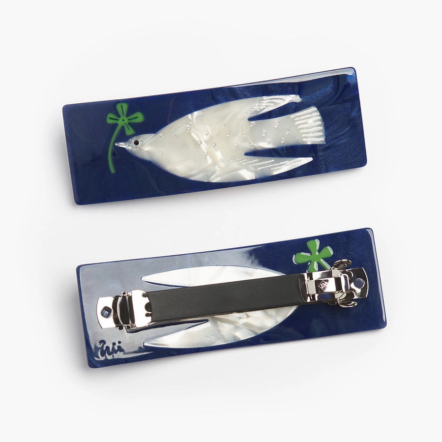 Set of nail clippers with a fish design on a blue background