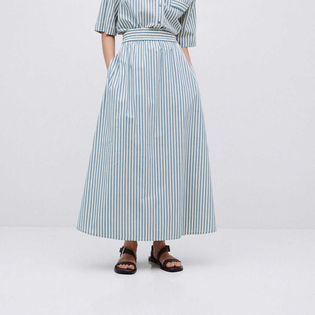 Blue and white striped maxi skirt with elastic waistband and pockets.