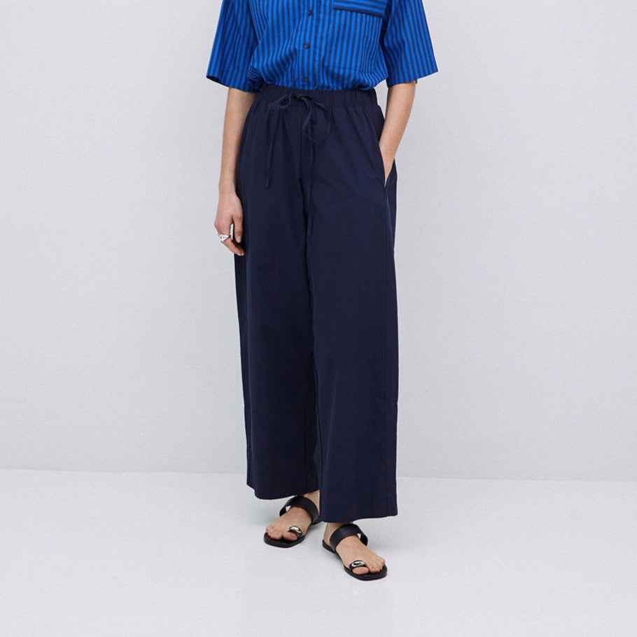Navy blue wide-leg pull-on pants with a drawstring waist.