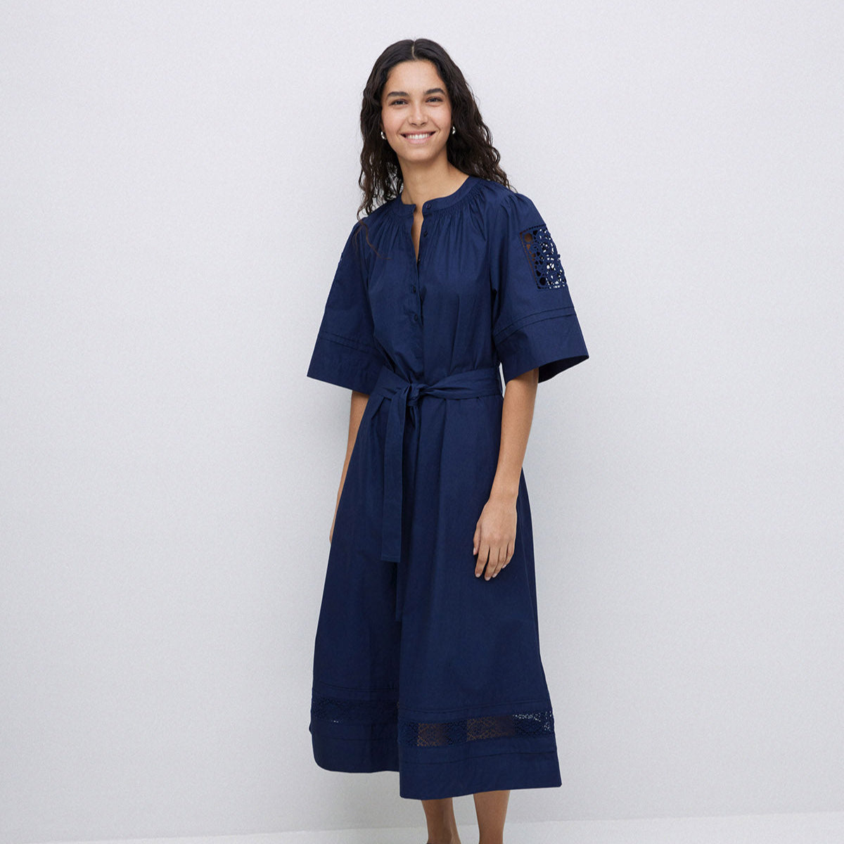 Navy blue midi dress with short sleeves, button front, self-tie belt, and lace trim at shoulders and hem.