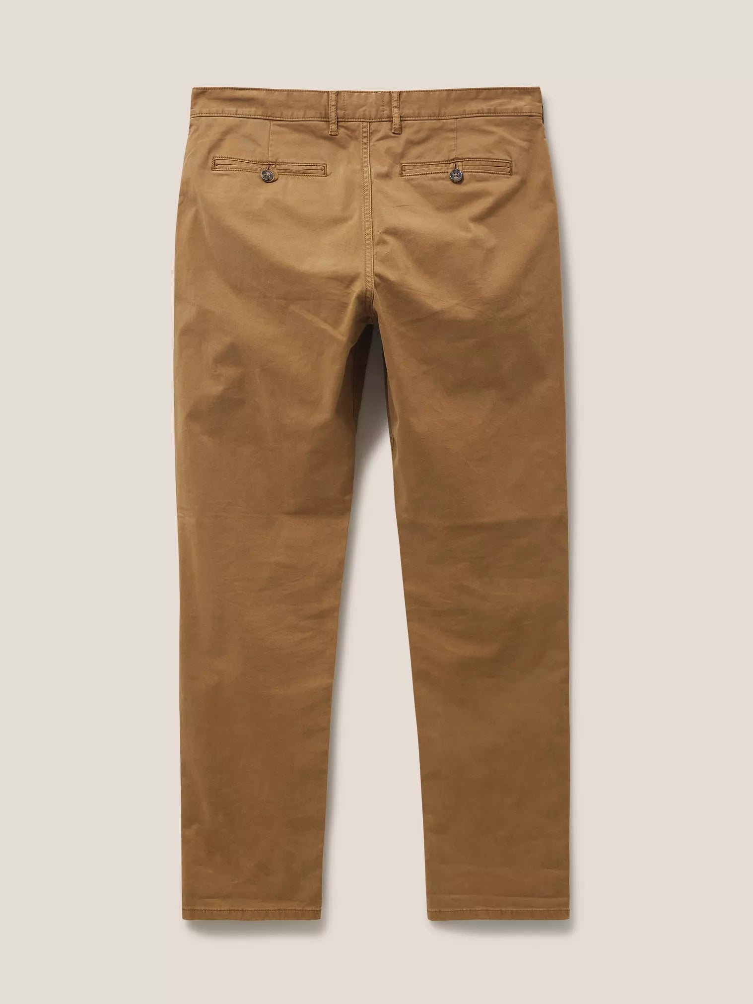 Brown chino trousers, viewed from the back, featuring a buttoned back pocket.