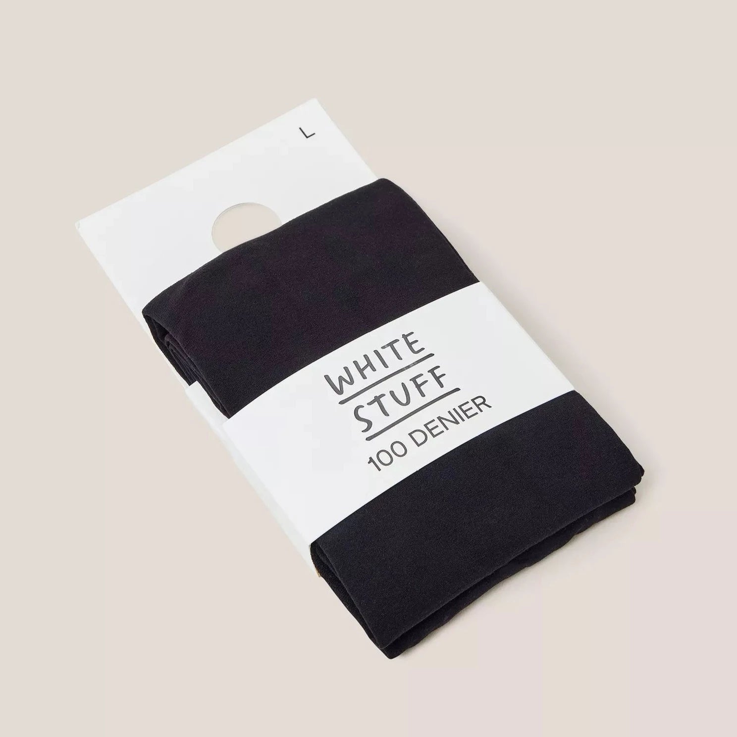 Black 100 denier tights folded on a white label, marked "WHITE STUFF".