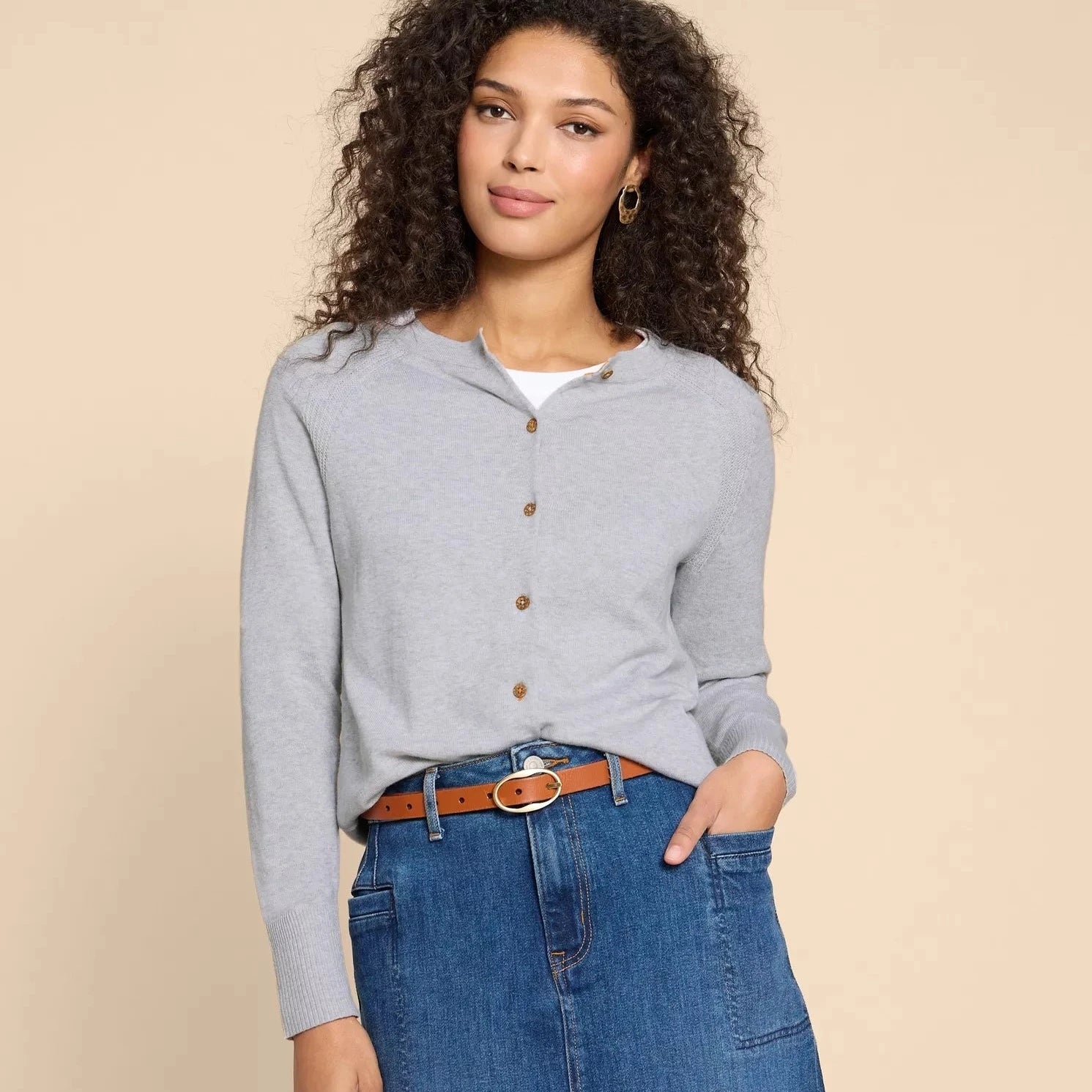 Light gray button-front cardigan sweater with long sleeves and ribbed cuffs.