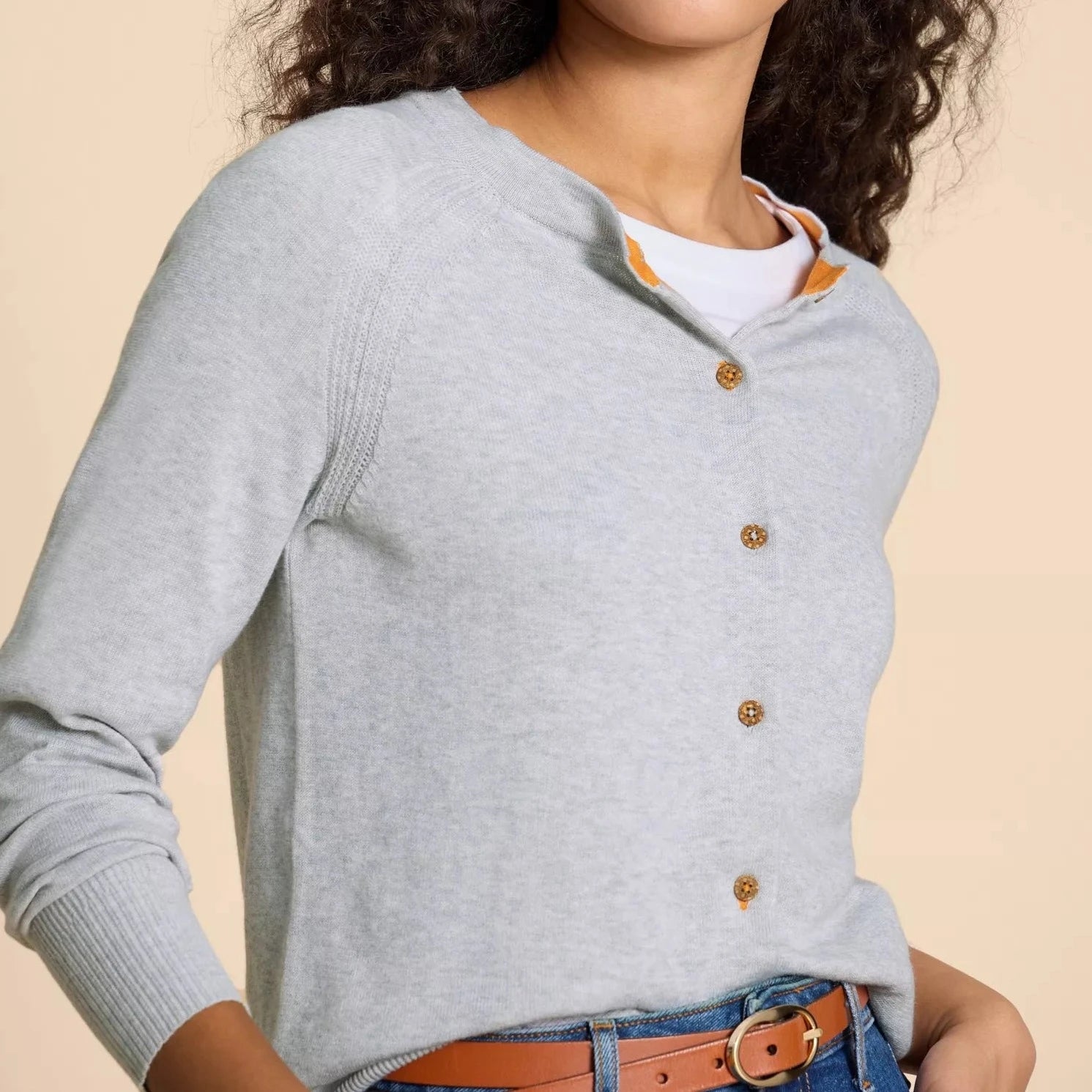 Light gray button-front cardigan with long sleeves and a subtle ribbed texture.