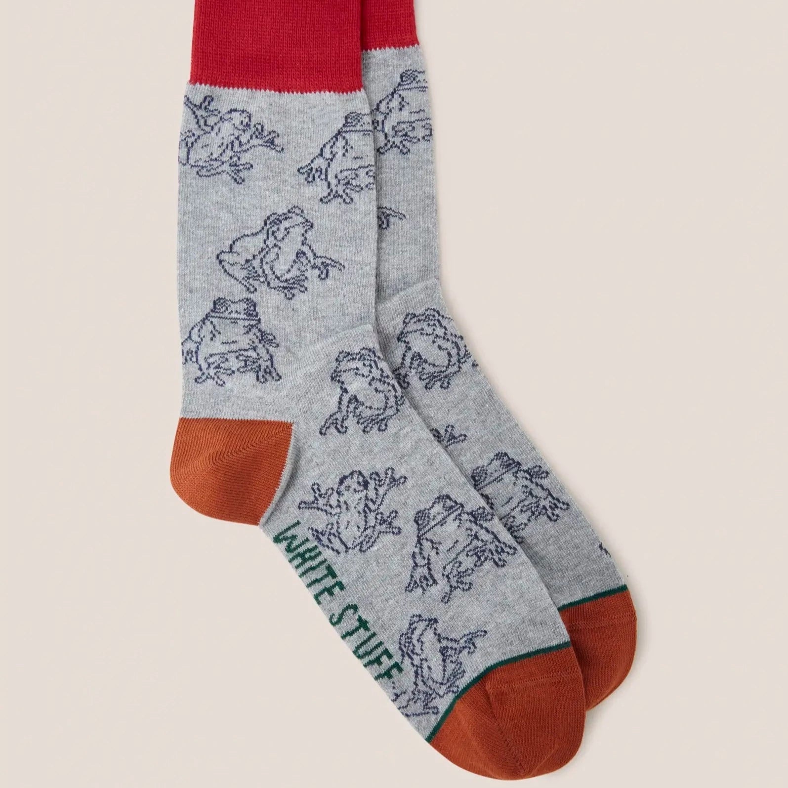 Pair of grey crew socks with a repeating frog pattern, red top cuffs, and orange bottoms.