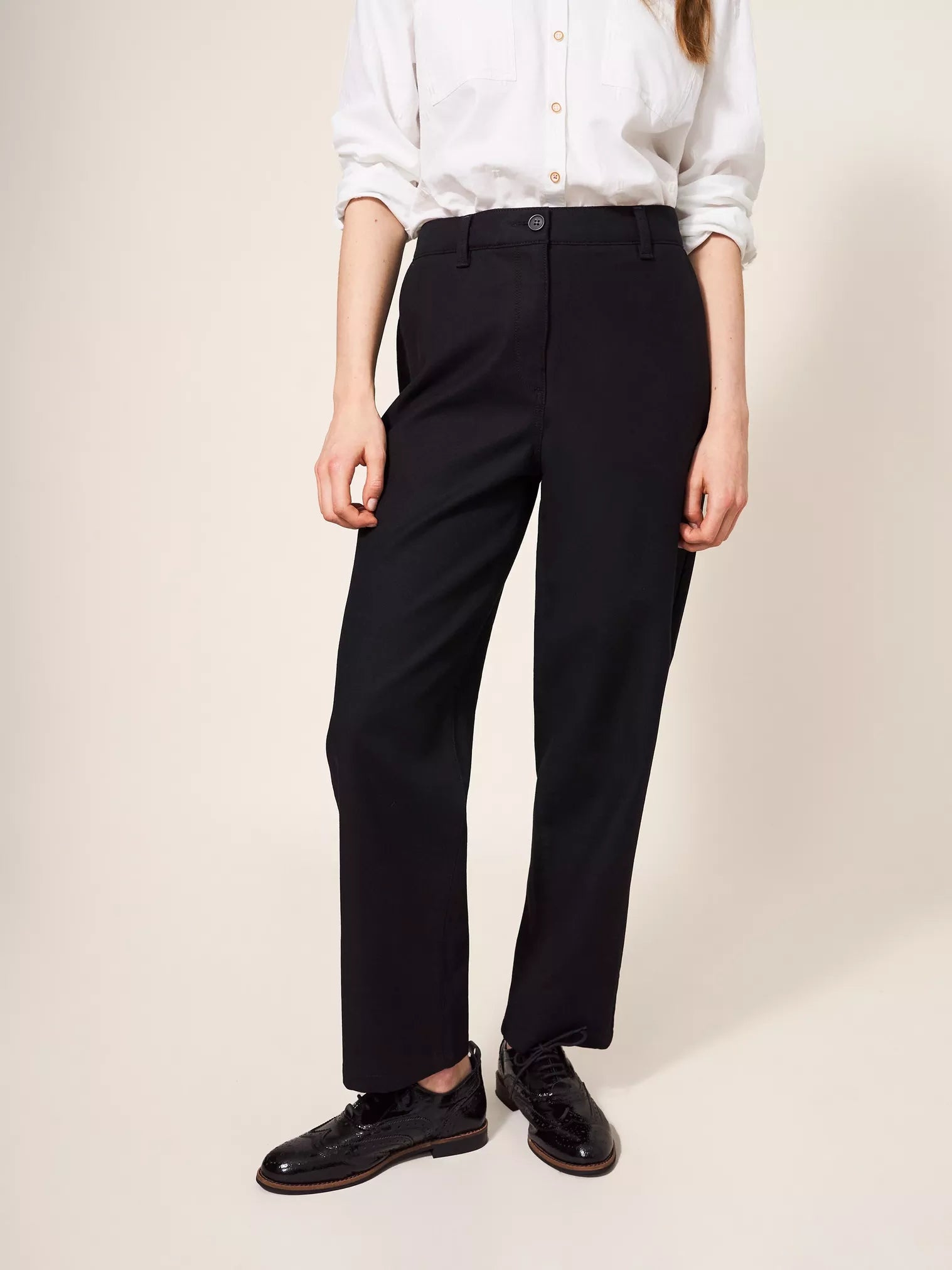 Black straight-leg trousers with a mid-rise waist and button closure.