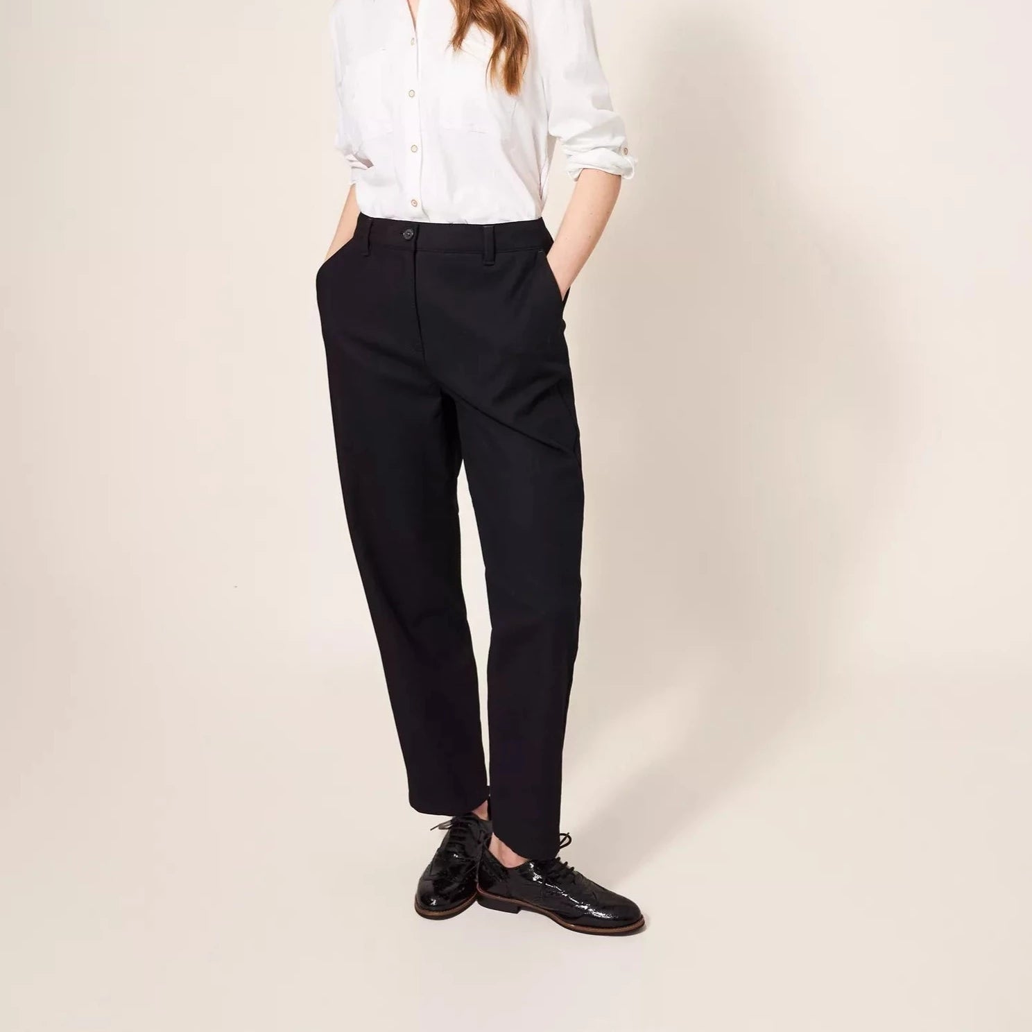 Black cropped trousers with a slightly loose fit and straight legs.