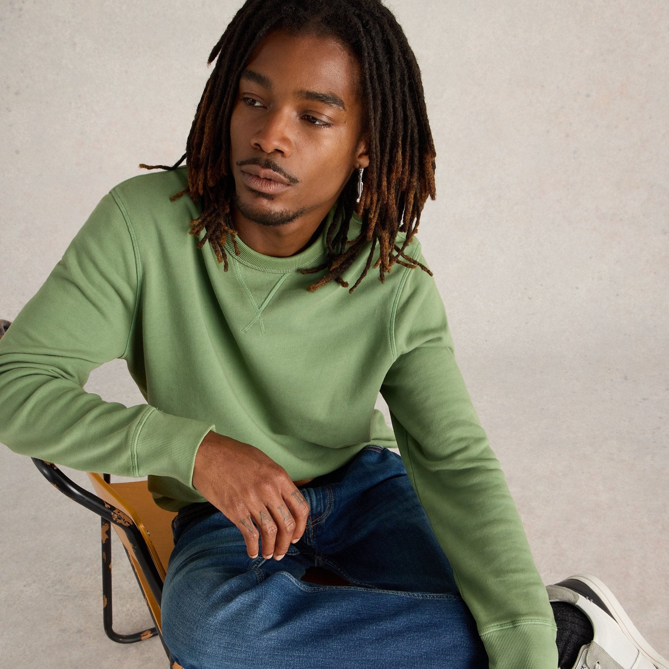 Sage green crewneck sweatshirt with long sleeves and ribbed cuffs.