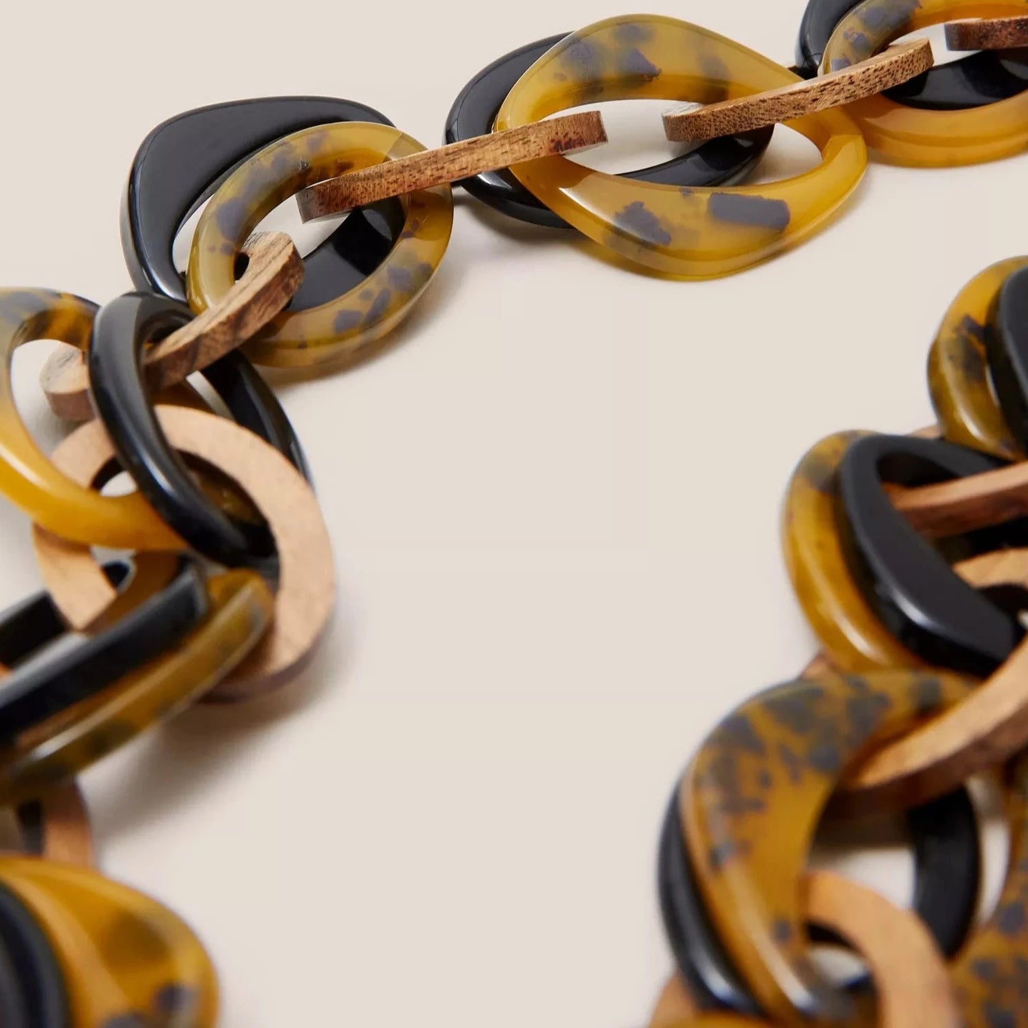Tortoiseshell and black resin chunky chain necklace with wood accents.