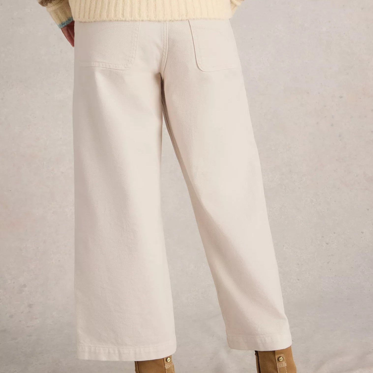 Off-white wide-leg cropped pants with front pockets.
