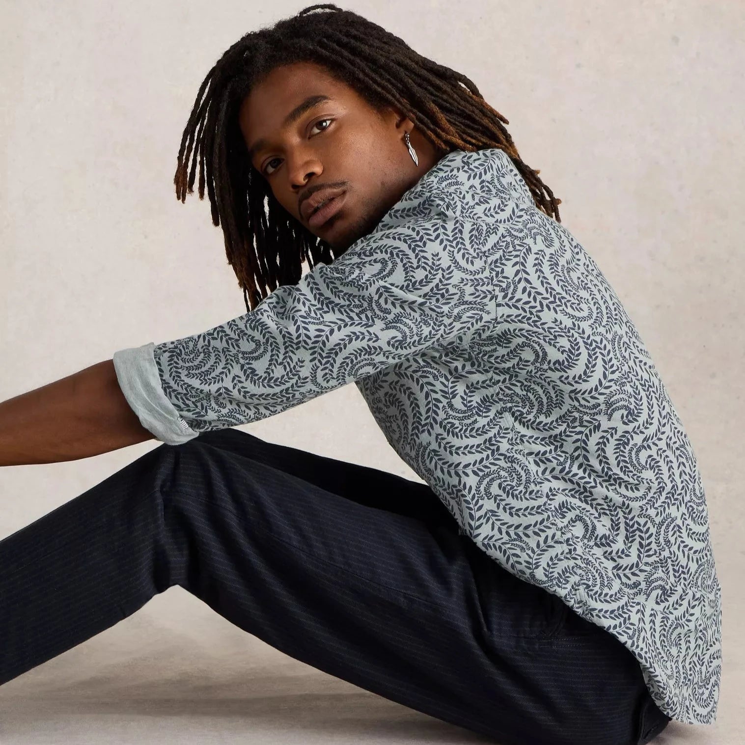 Sage green long-sleeve shirt with a dark-grey leaf pattern.