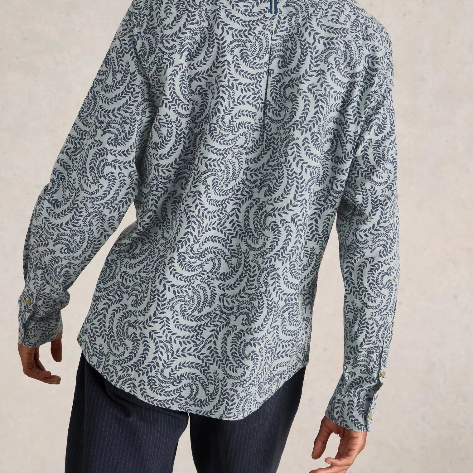 Men's long-sleeve shirt in light blue with a dark blue swirling leaf pattern.