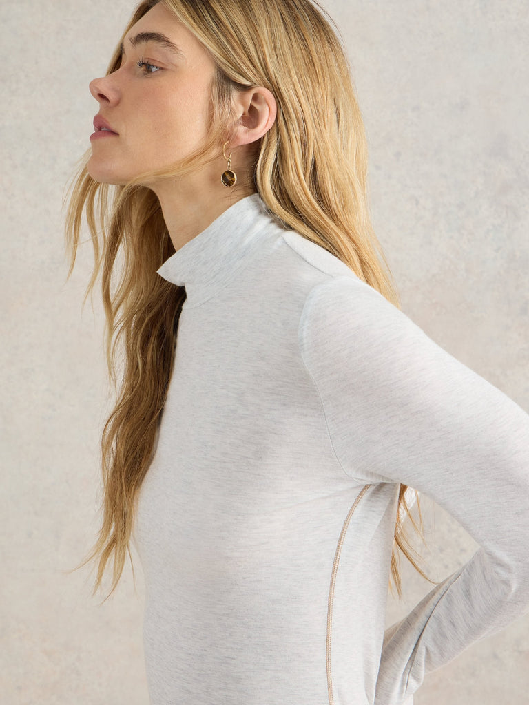 Light gray heather long-sleeve mock neck shirt with subtle side seam detail.