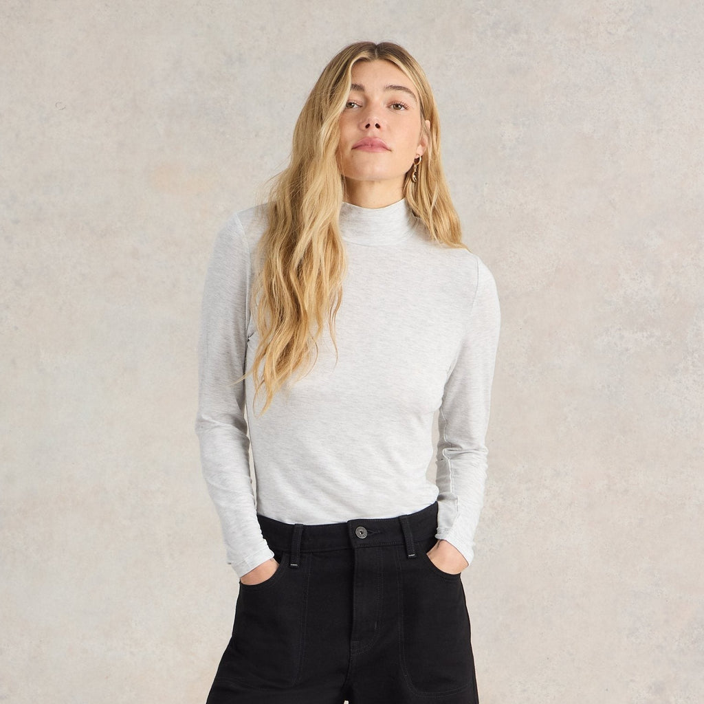 Light gray long-sleeve mock neck shirt. The shirt is fitted and appears to be made of a soft, slightly textured fabric.