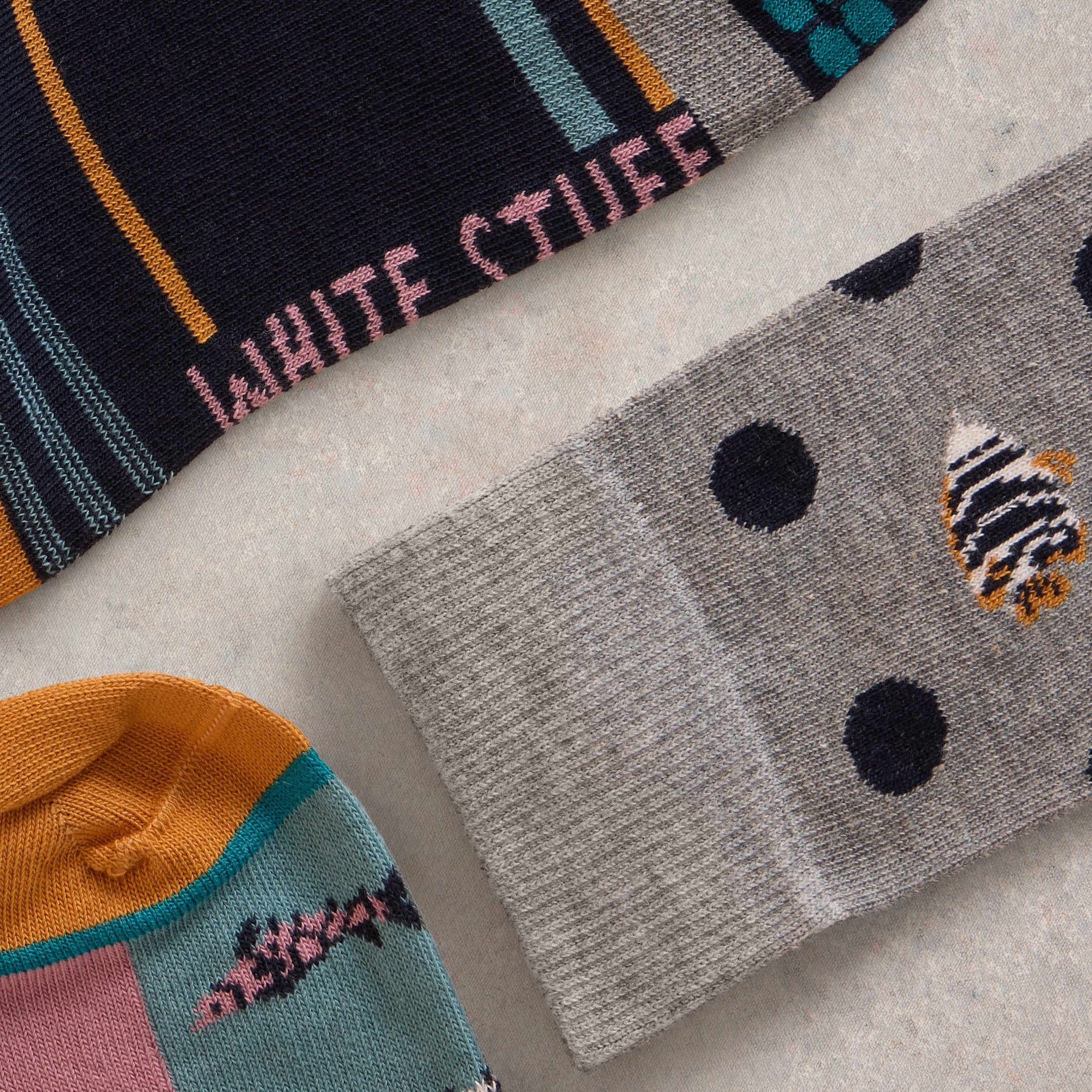 Three pairs of colorful knit socks.