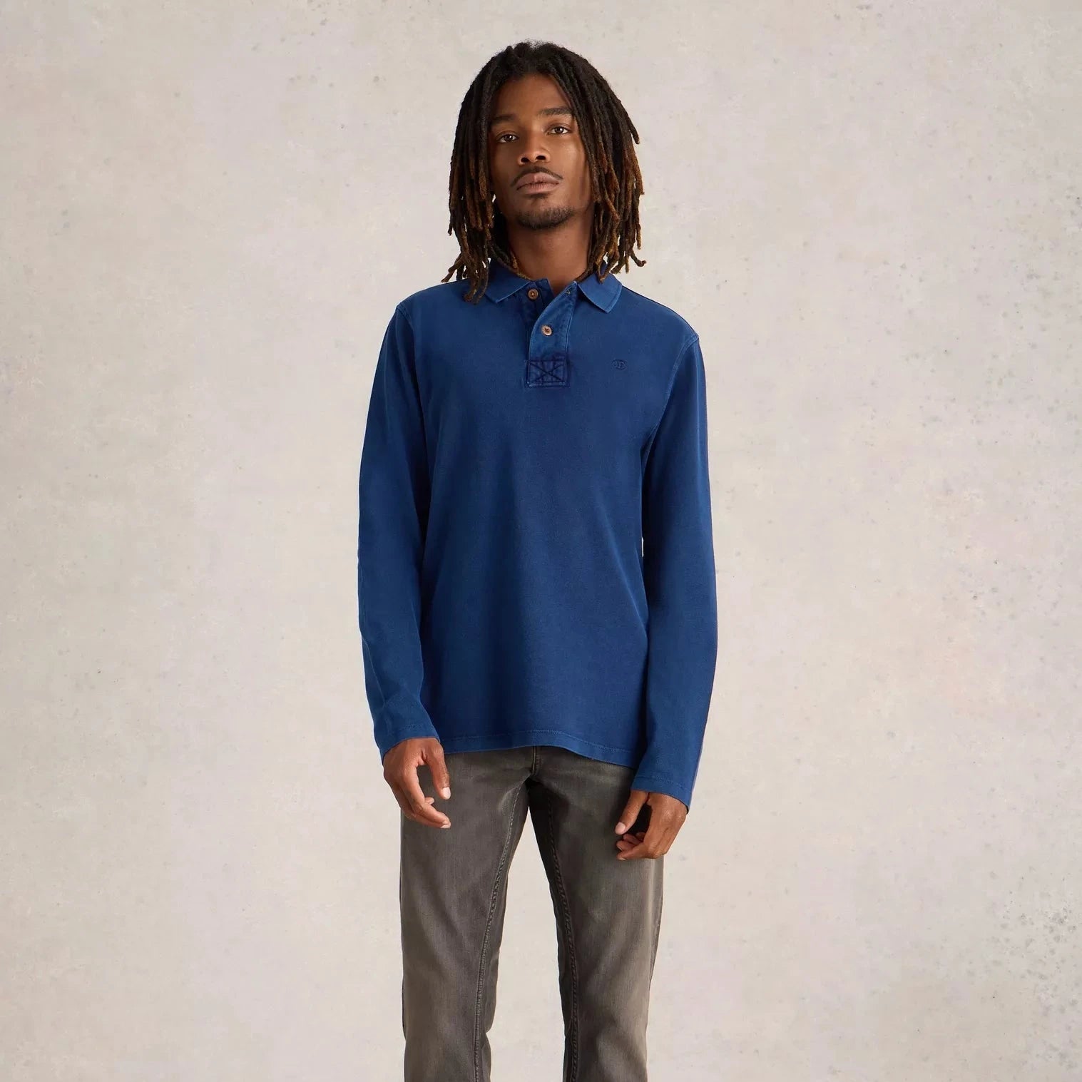 Long-sleeve, dark blue cotton polo shirt with embroidered detail on chest.