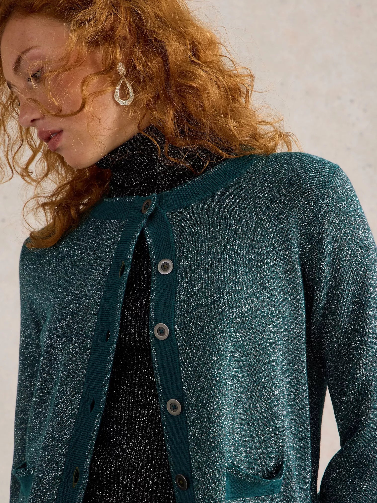 Sparkly teal green cardigan sweater with button front and patch pockets.