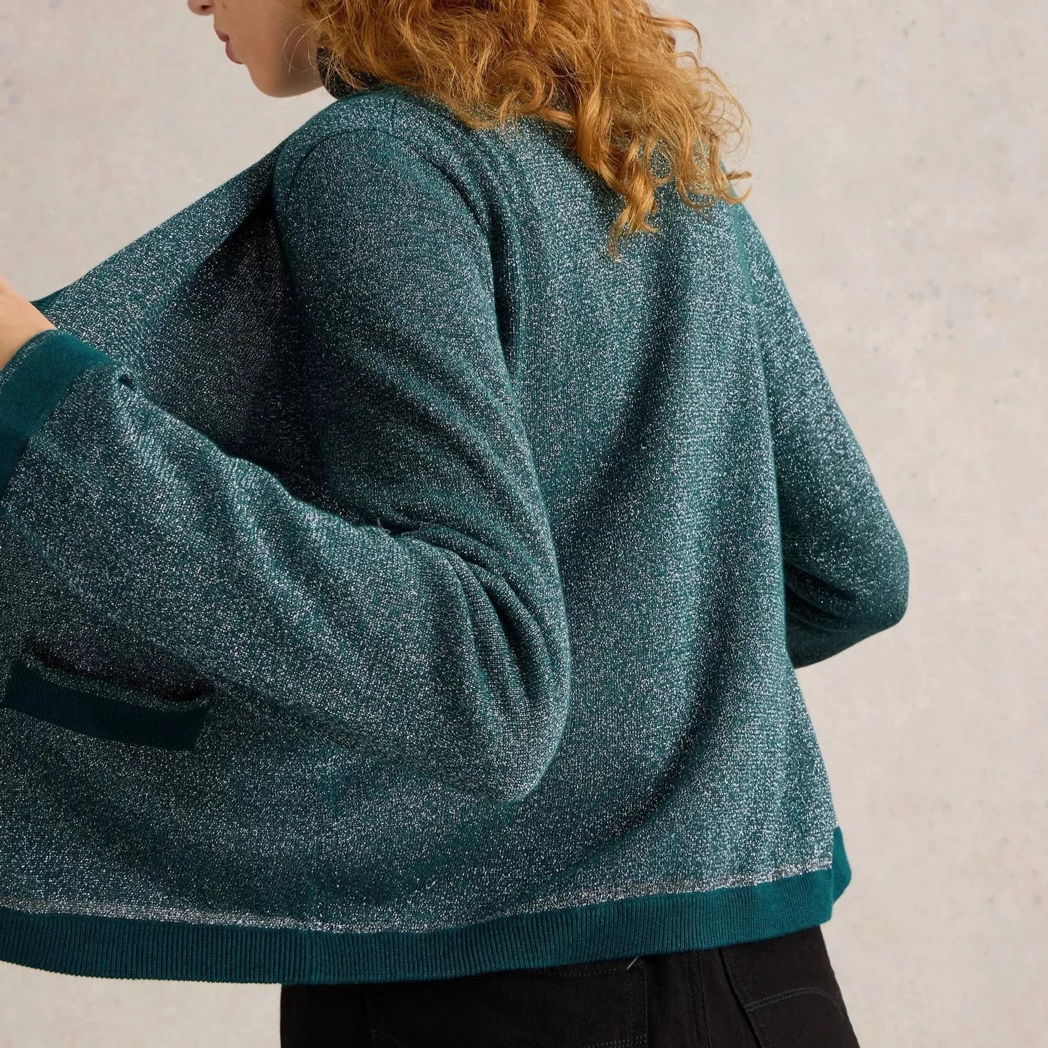 Teal glitter knit cardigan with ribbed hem and cuffs.
