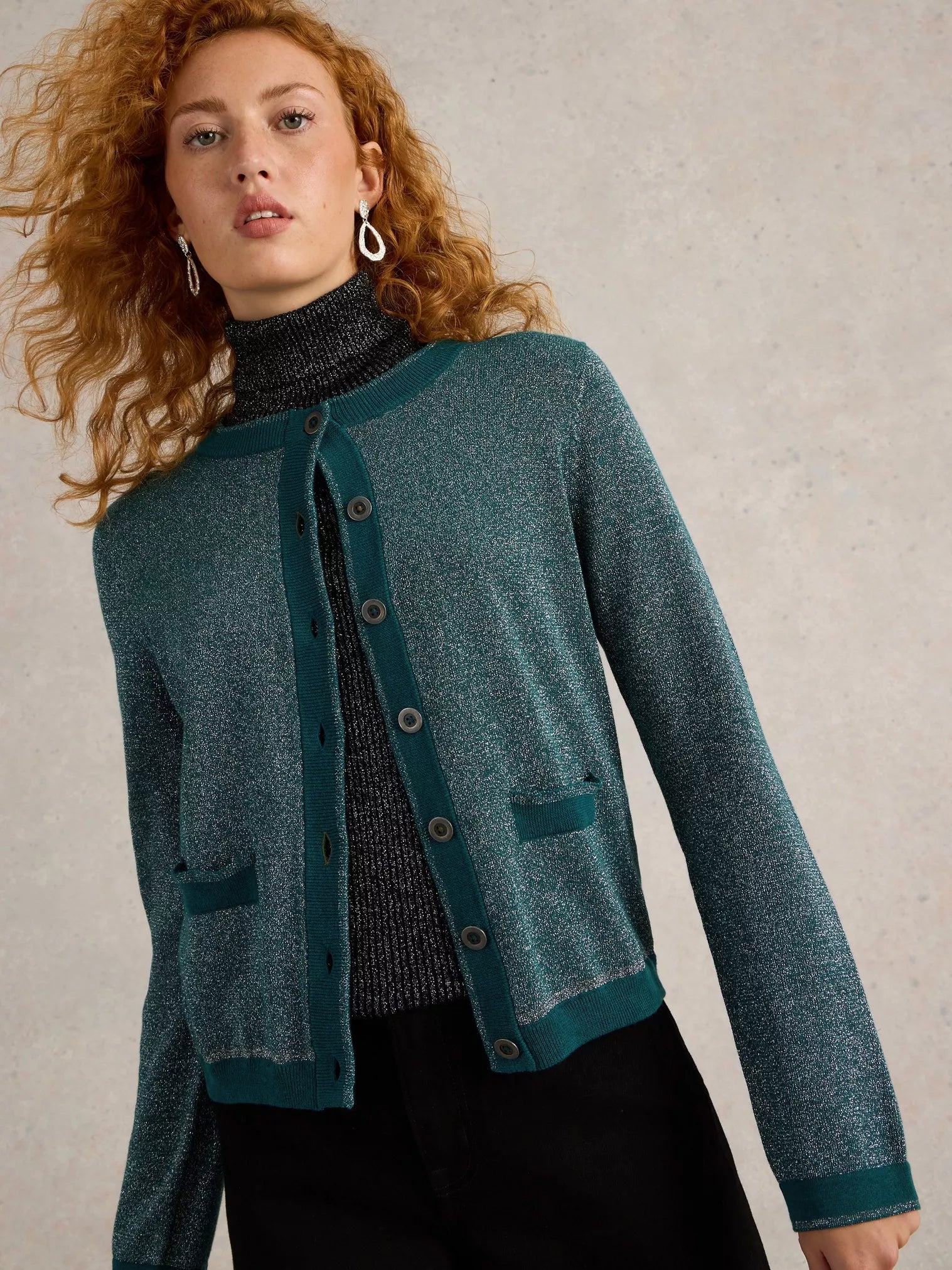 Sparkly teal green button-front cardigan with ribbed trim and patch pockets.
