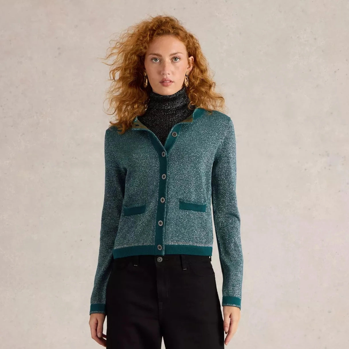 Teal sparkly button-front cardigan with patch pockets and dark teal trim.